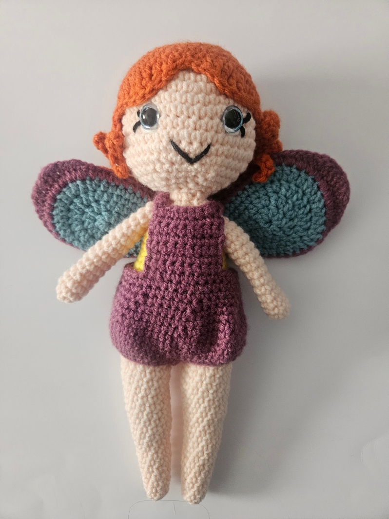 Product Description: Materials used: Yarn, Polyfil, Safety Eyes</br></br>Dimensions: 9wx12hx4w inches</br>Cute amigurumi character. Unique gift for family and pets. Assorted colors.</br></br>Artist Statement: Crochet is one of my favorite mediums for artistic expression, where yarn and a hook become the tools through which I craft whimsical characters and imaginative worlds. With each stitch, life is given to these soft sculptures, transforming simple materials into endearing creatures. My work in Amigurumi crochet is a testament to the power of handmade artistry, as each piece has their own unique personality and charm. Through this craft, I seek a sense of wonder, joy, and nostalgia in those who encounter my creations, inviting them to embrace the magic of the handmade and the infinite possibilities of yarn.</br></br>Bio: Casey Lucas is a versatile artist with a background in both dance and visual arts. She earned her Bachelor of Fine Arts (BFA) in Dance from Mason Gross School of the Arts and a Master of Fine Arts (MFA) in Art - Ceramics from Kean University. Casey's artistic journey spans various creative mediums, including Amigurumi crochet and ceramics, through which she brings her unique vision to life. After living in New York City for over a decade, she currently resides in the picturesque town of Princeton, New Jersey. Casey shares her life with her husband and two children, drawing inspiration from the town's historic charm. Her work beautifully combines the tactile and visual arts, creating a seamless fusion of movement, texture, and form. Whether through the fluidity of dance or the intricacies of crochet and ceramics, Casey's artistry is a testament to her unwavering commitment to the creative process. Beyond her artistic pursuits, Casey is a recent breast cancer survivor, showcasing incredible resilience and strength throughout her personal journey. She has chosen to use her art as a force for good, dedicating a portion of her sales to support cancer research. Her work not only embodies creativity and passion but also carries a profound message of hope and determination.</br></br>Sold individually.</br>$45 each *</br>Price subject to sales tax.</br></br>Item Number: CL64</br> Amigurumi Fairies by Casey Lucas
